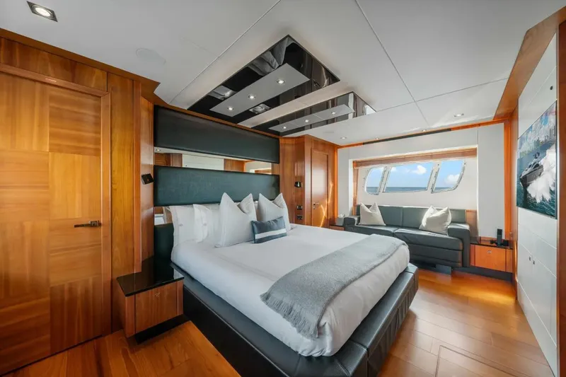 Slide: The Image of Luxurious Sunseeker Predator 84 yacht bedroom interior, featuring elegant wood finishes and ocean view. - 44