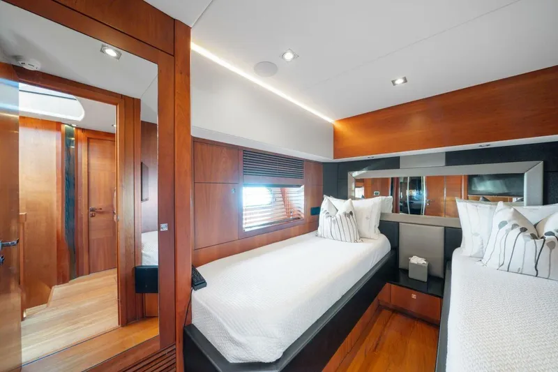 Slide: The Image of Luxurious twin bedroom on 2010 Sunseeker Predator 84 yacht, featuring elegant wood finishes. - 47