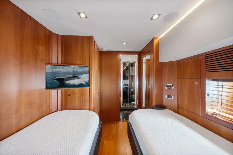 Slide: The Image of Luxurious Sunseeker Predator 84 yacht interior with twin beds, wood paneling, and modern amenities. - 48