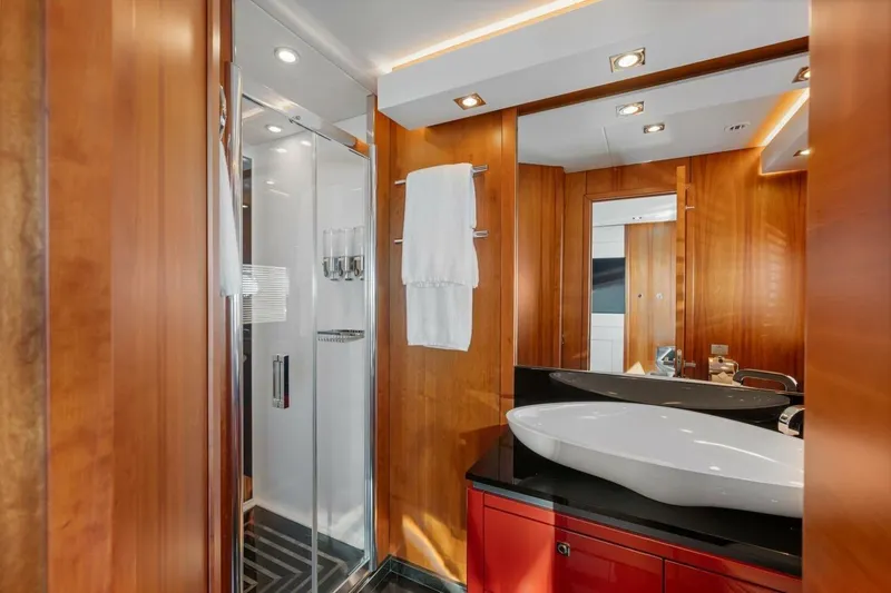 Slide: The Image of Luxurious bathroom on 2010 Sunseeker Predator 84 yacht with modern fixtures and wood paneling. - 53