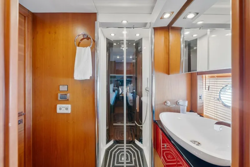 Slide: The Image of Luxurious bathroom on 2010 Sunseeker Predator 84 yacht with modern fixtures and wood accents. - 56