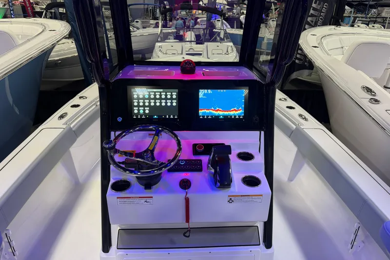 Slide: The Image of 2026 Sportsman Masters 267OE Bay Boat dashboard with modern controls and navigation display. - 4