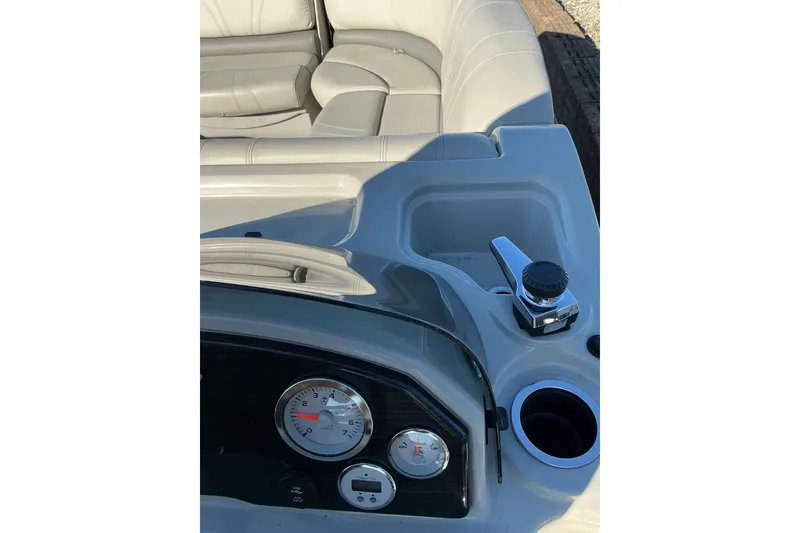 Slide: The Image of 2016 Starcraft SLS 3 boat dashboard with gauges and seating area. - 12