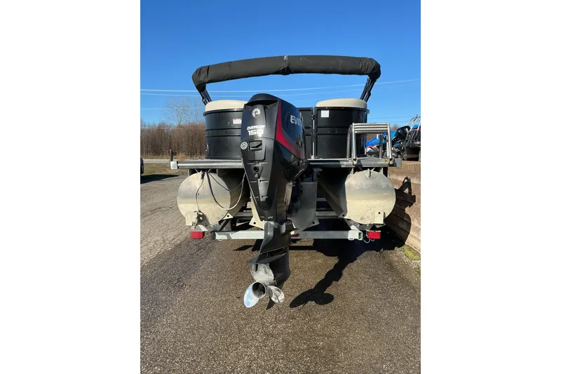 Slide: The Image of 2016 Starcraft SLS 3 pontoon boat with Evinrude 150 outboard motor, parked on pavement. - 3