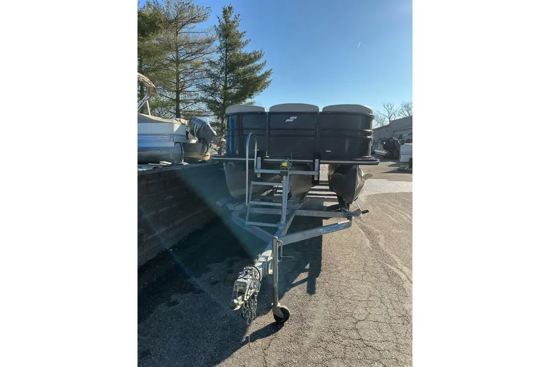 Slide: The Image of 2016 Starcraft SLS 3 pontoon boat on trailer, parked outdoors. - 4