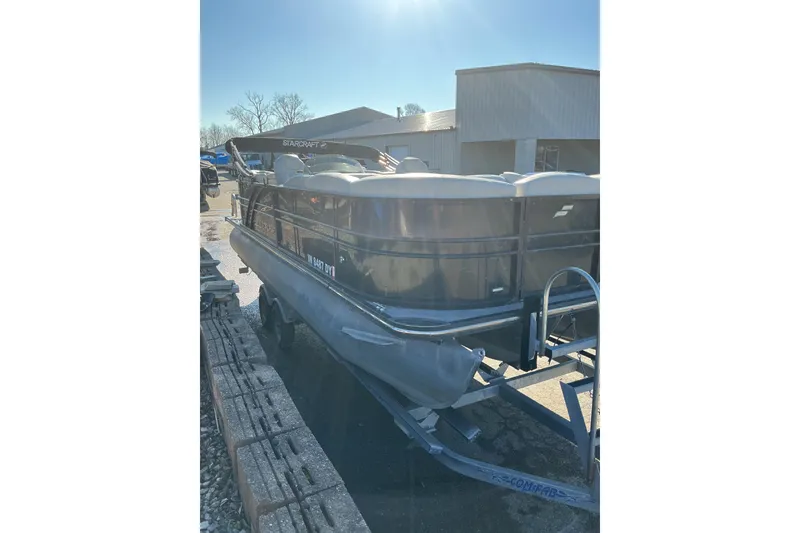 Slide: The Image of 2016 Starcraft SLS 3 pontoon boat on trailer in sunny outdoor setting. - 5