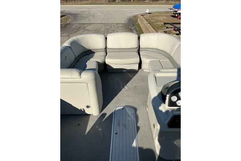 Slide: The Image of 2016 Starcraft SLS 3 pontoon boat interior with beige seating and steering console. - 8
