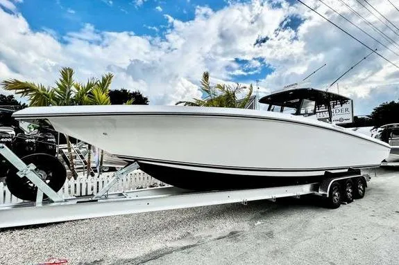 Slide: The Image of 2023 Fountain 38 Tournament Edition boat on trailer, under a partly cloudy sky. - 10