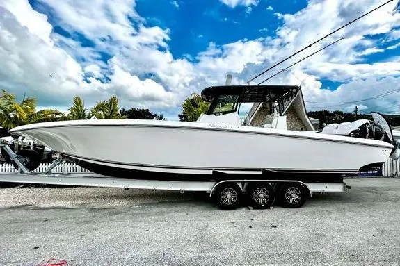 Slide: The Image of 2023 Fountain 38 Tournament Edition boat on trailer under a vibrant blue sky. - 11