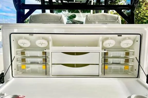 Slide: The Image of 2023 Fountain 38 Tournament Edition boat storage compartment with organized tackle boxes and drawers. - 14