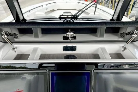 Slide: The Image of 2023 Fountain 38 Tournament Edition boat dashboard with storage compartments and modern controls. - 32