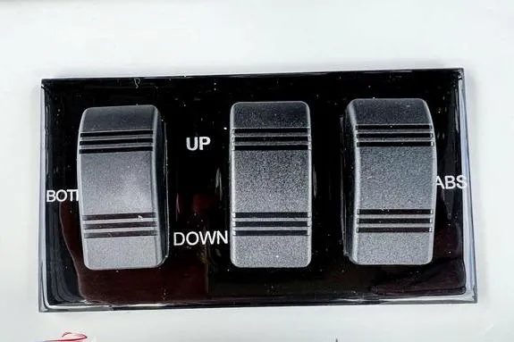 Slide: The Image of Control panel of 2023 Fountain 38 Tournament Edition boat with labeled switches. - 34
