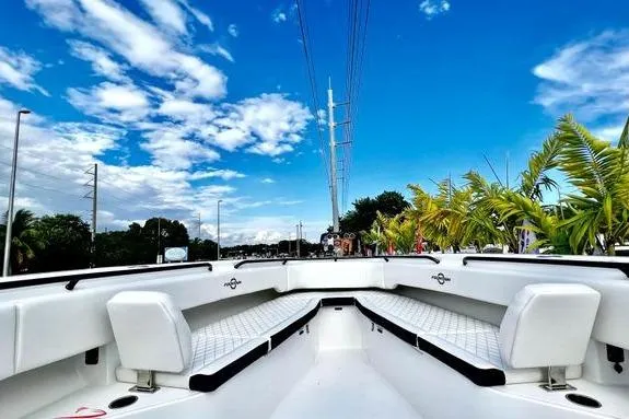 Slide: The Image of 2023 Fountain 38 Tournament Edition boat with white seating, under a vibrant blue sky. - 36