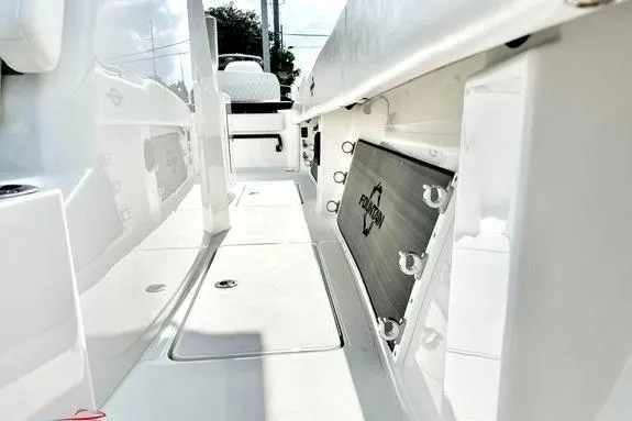 Slide: The Image of 2023 Fountain 38 Tournament Edition boat interior, showcasing sleek white deck and storage compartments. - 39