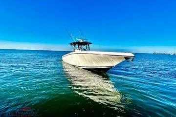 Slide: The Image of 2023 Fountain 38 Tournament Edition boat on calm blue water under clear sky. - 4