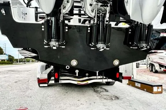 Slide: The Image of 2023 Fountain 38 Tournament Edition boat on trailer, rear view showing engines and hull. - 7