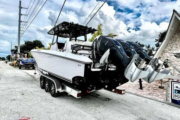 Slide: The Image of 2023 Fountain 38 Tournament Edition boat on trailer with triple outboard engines. - 9