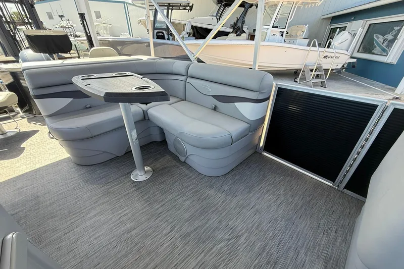 Slide: The Image of 2022 Bennington 22 SS Fish and Cruise boat interior with gray seating and table. - 10