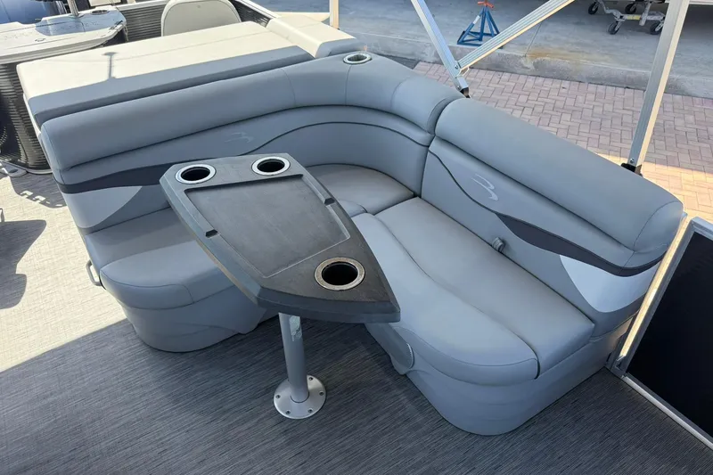 Slide: The Image of 2022 Bennington 22 SS Fish and Cruise boat interior with gray seating and table. - 11