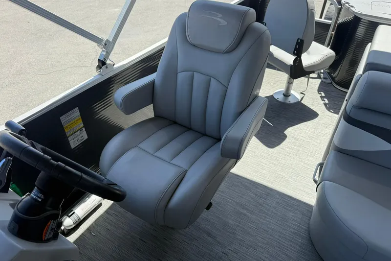 Slide: The Image of 2022 Bennington 22 SS Fish and Cruise boat interior with gray captain's chair and steering wheel. - 12