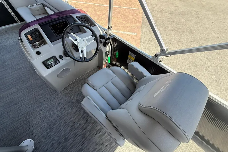 Slide: The Image of 2022 Bennington 22 SS Fish and Cruise boat helm with steering wheel and captain's chair. - 13