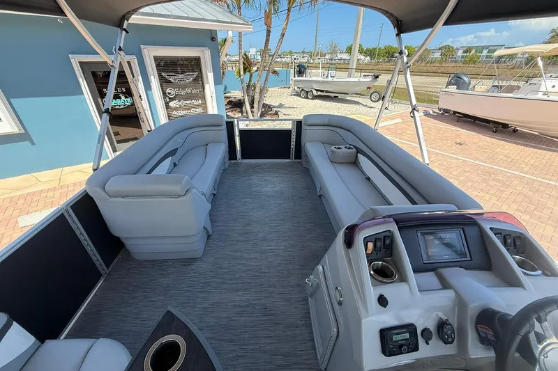 Slide: The Image of 2022 Bennington 22 SS Fish and Cruise pontoon boat interior with seating and control panel. - 15