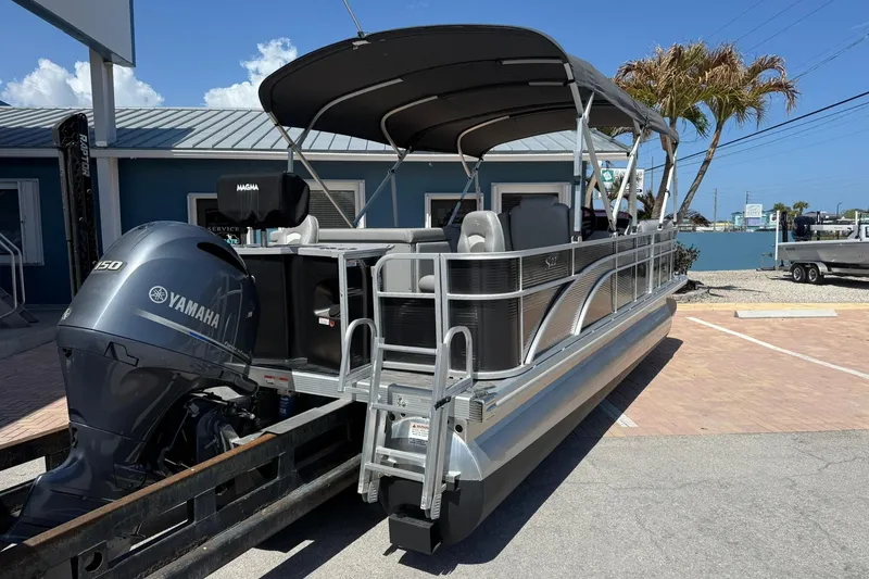 Slide: The Image of 2022 Bennington 22 SS Fish and Cruise pontoon boat with Yamaha engine, docked outdoors. - 2