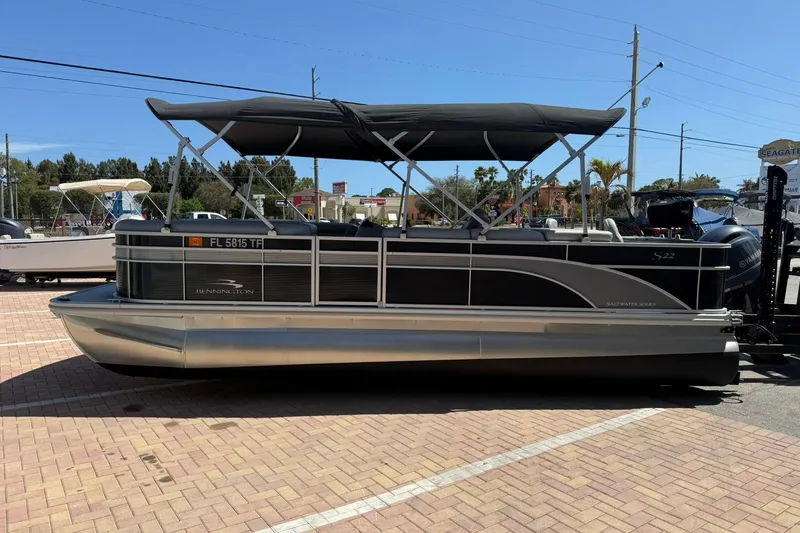 Slide: The Image of 2022 Bennington 22 SS Fish and Cruise pontoon boat with canopy, parked on brick pavement. - 4