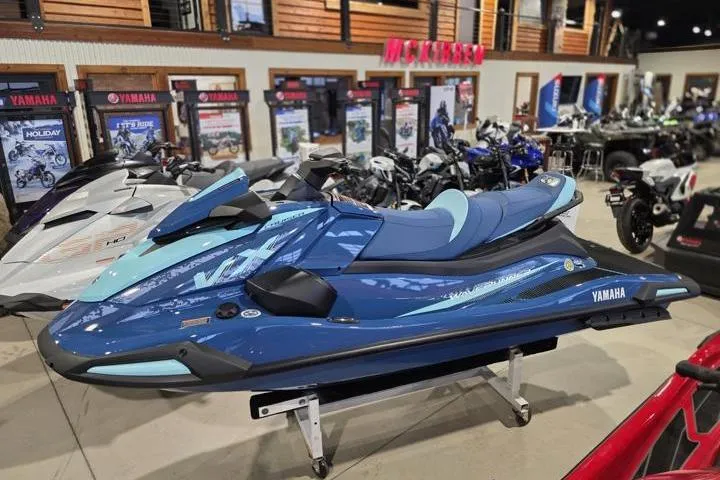 Slide: The Image of 2026 Yamaha WaveRunner VX Cruiser in showroom, blue color, displayed among other vehicles. - 3