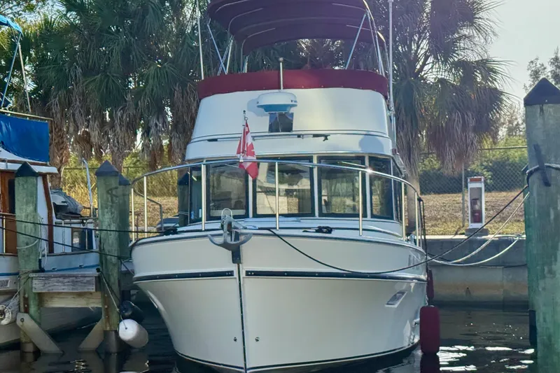 Slide: The Image of 2002 Camano Troll boat docked with Canadian flag, surrounded by palm trees. - 3