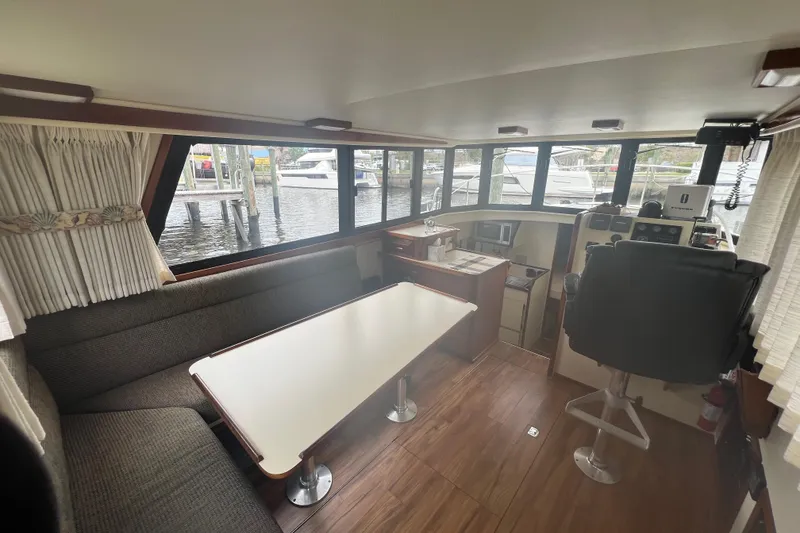 Slide: The Image of Interior of 2002 Camano Troll boat with seating, table, and helm station. - 5