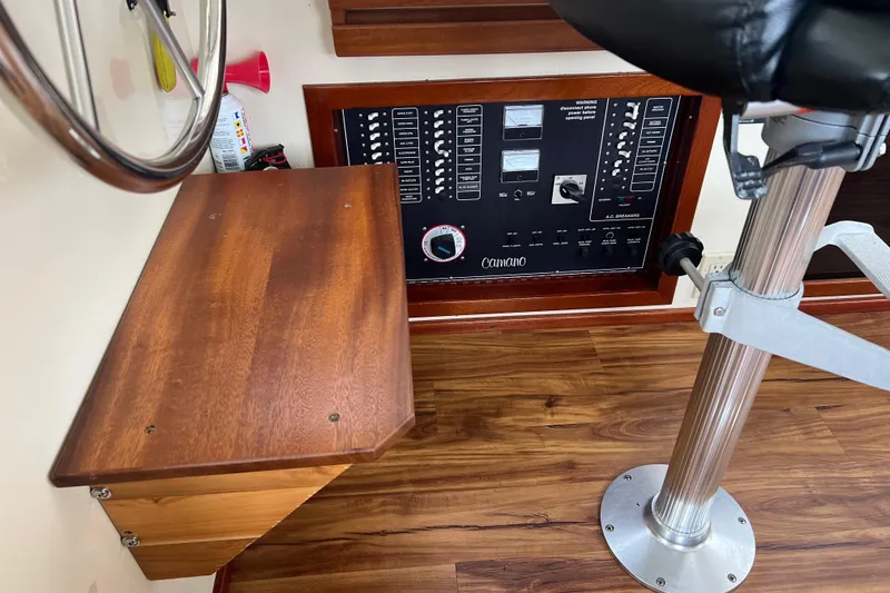 Slide: The Image of Control panel of a 2002 Camano Troll boat with wooden accents and seating. - 7