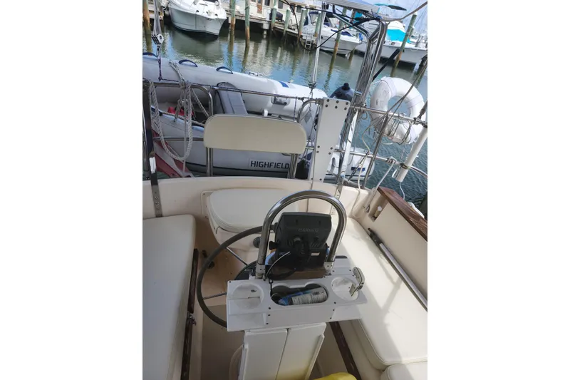 Slide: The Image of Cockpit of a 1994 Island Packet 32 sailboat with steering wheel and seating. - 10