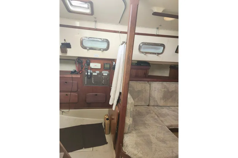 Slide: The Image of 1994 Island Packet 32 yacht interior with navigation panel and seating area. - 16