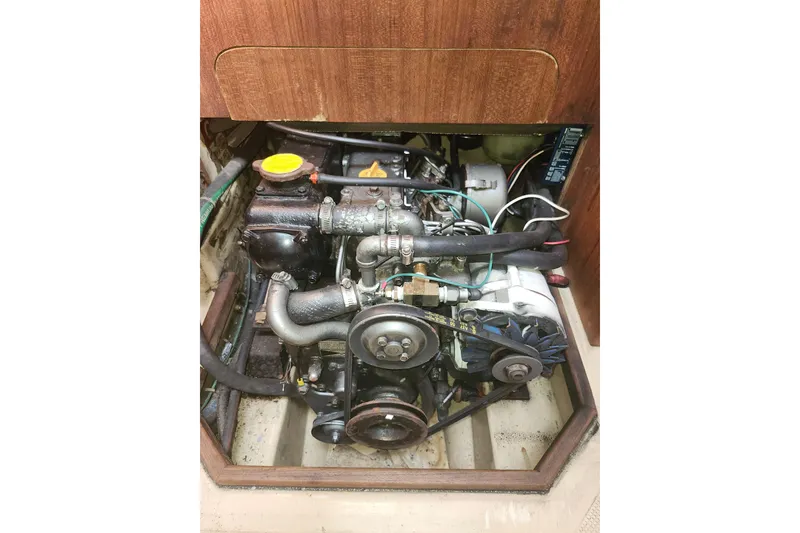 Slide: The Image of Engine compartment of a 1994 Island Packet 32 sailboat, showcasing mechanical components. - 20