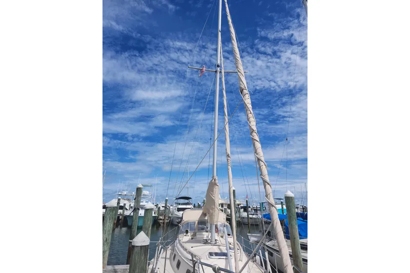 Slide: The Image of Sailboat docked at marina under blue sky, Island Packet 32, 1994 model. - 3