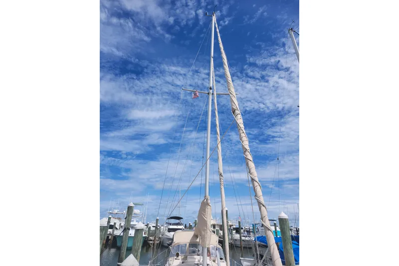 Slide: The Image of Sailboat docked at marina under blue sky, Island Packet 32, 1994 model. - 4