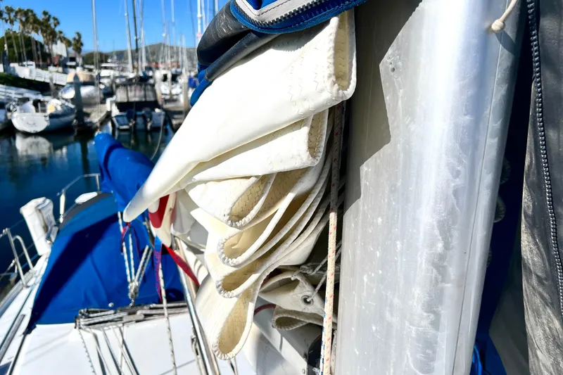 Slide: The Image of Folded sail on a 1999 Catalina 36 MkII sailboat, docked in a marina. - 11