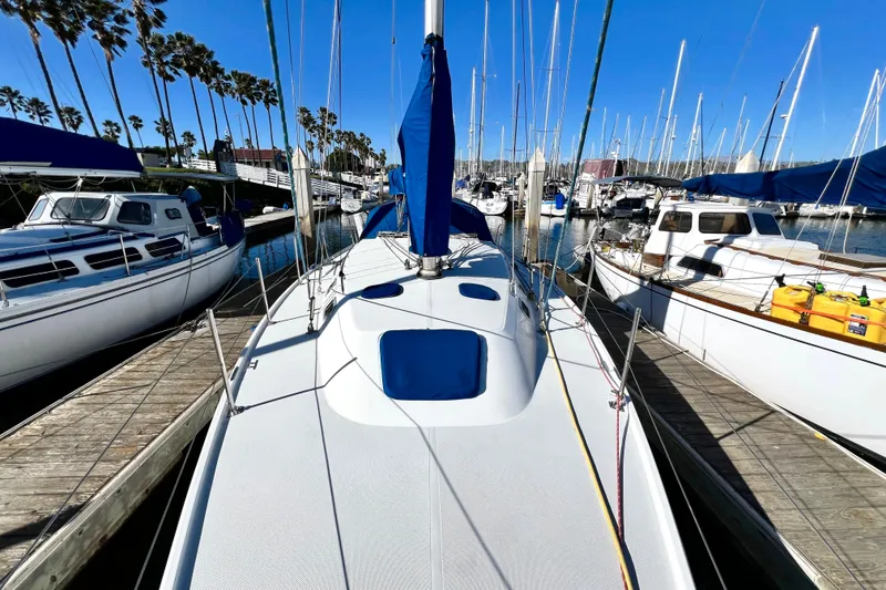 Slide: The Image of Catalina 36 MkII 1999 sailboat docked in a sunny marina with palm trees. - 15
