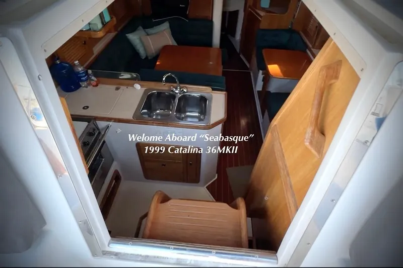 Slide: The Image of Interior view of 1999 Catalina 36 MkII yacht, featuring kitchen and seating area. - 22