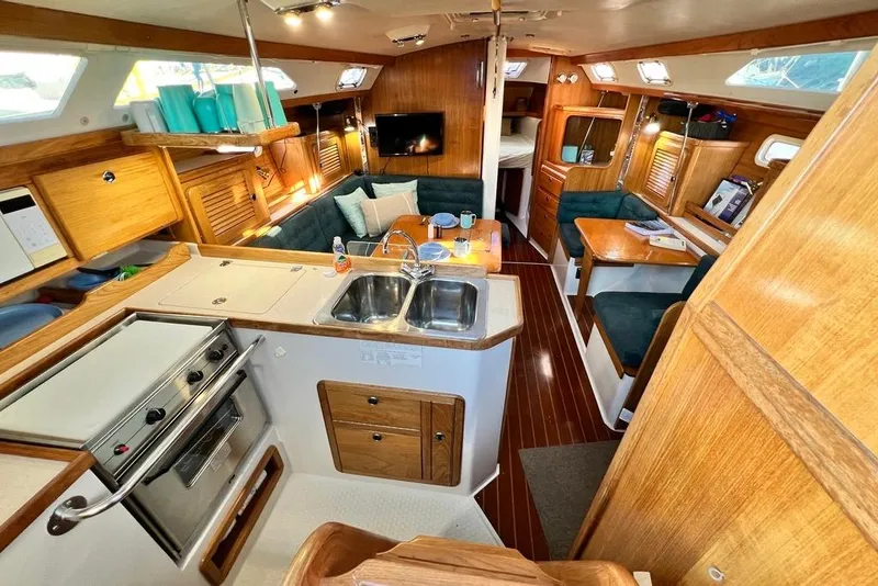 Slide: The Image of Interior of a 1999 Catalina 36 MkII sailboat with kitchen and seating area. - 23