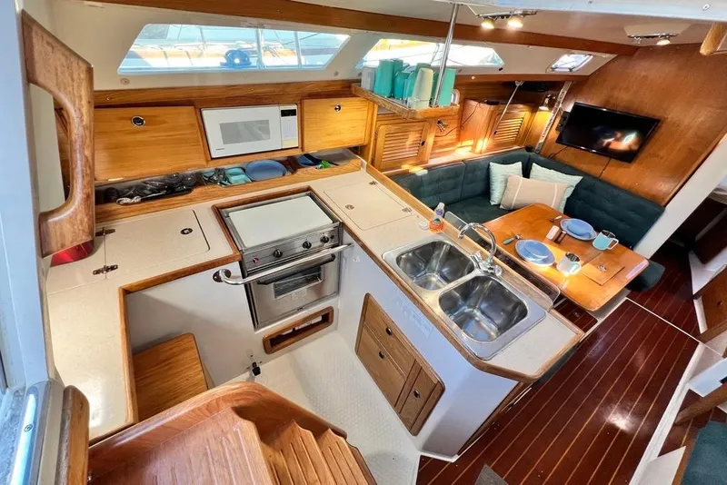 Slide: The Image of Interior of 1999 Catalina 36 MkII sailboat with kitchen and dining area. - 24