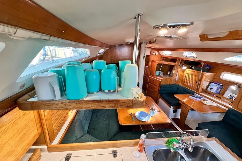 Slide: The Image of Interior of a 1999 Catalina 36 MkII sailboat with kitchen and dining area. - 28