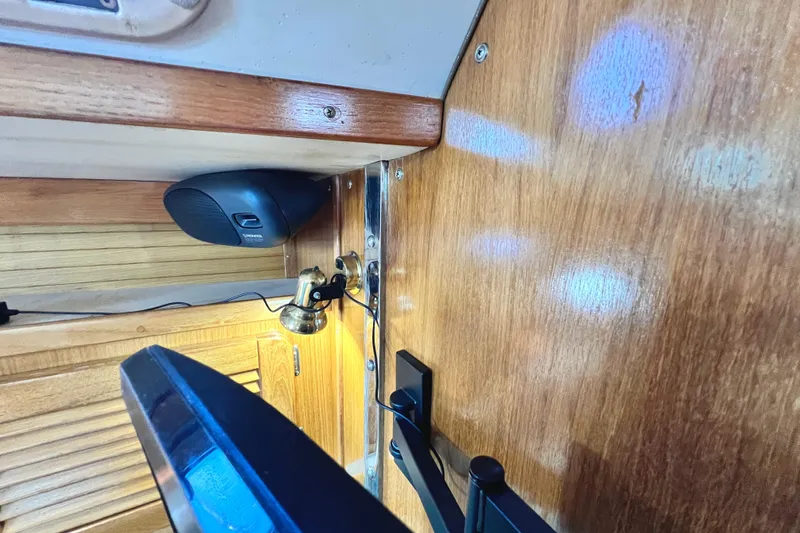 Slide: The Image of Interior of 1999 Catalina 36 MkII sailboat with wooden paneling and mounted speaker. - 32