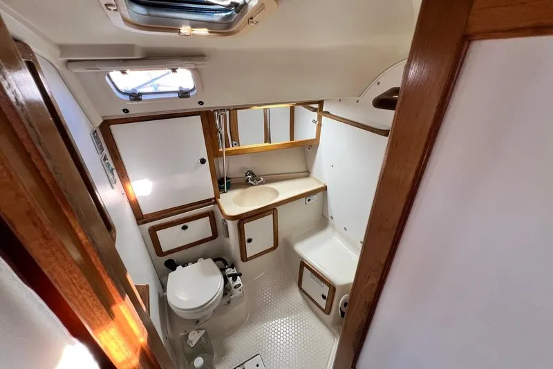 Slide: The Image of 1999 Catalina 36 MkII yacht bathroom with sink, toilet, and wooden accents. - 34