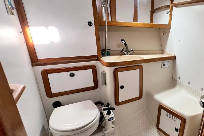 Slide: The Image of 1999 Catalina 36 MkII yacht bathroom with sink, toilet, and wooden cabinetry. - 35