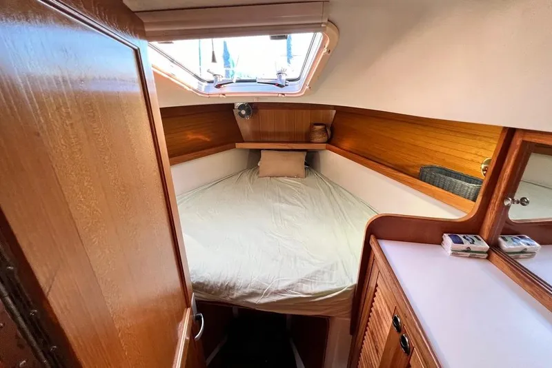Slide: The Image of Cozy cabin interior of a 1999 Catalina 36 MkII sailboat with wooden accents. - 36