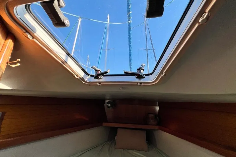 Slide: The Image of Cabin view from a 1999 Catalina 36 MkII sailboat, showing a skylight and masts. - 37