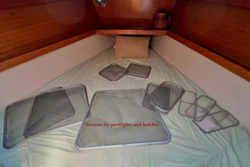 Slide: The Image of Screens for portholes and hatches on a 1999 Catalina 36 MkII sailboat interior. - 38