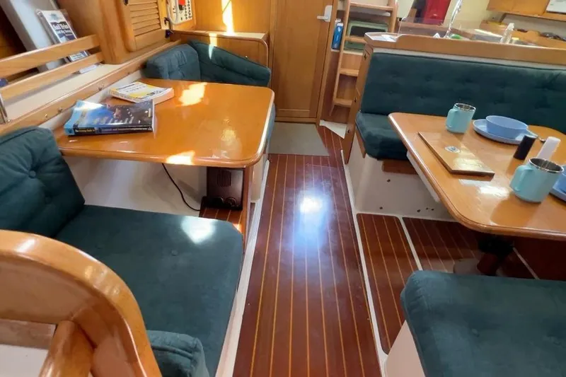 Slide: The Image of Interior of a 1999 Catalina 36 MkII sailboat with cozy seating and wooden tables. - 41